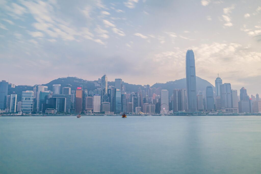 Stunning view of Hong Kong skyline from Victoria Harbour during daylight.